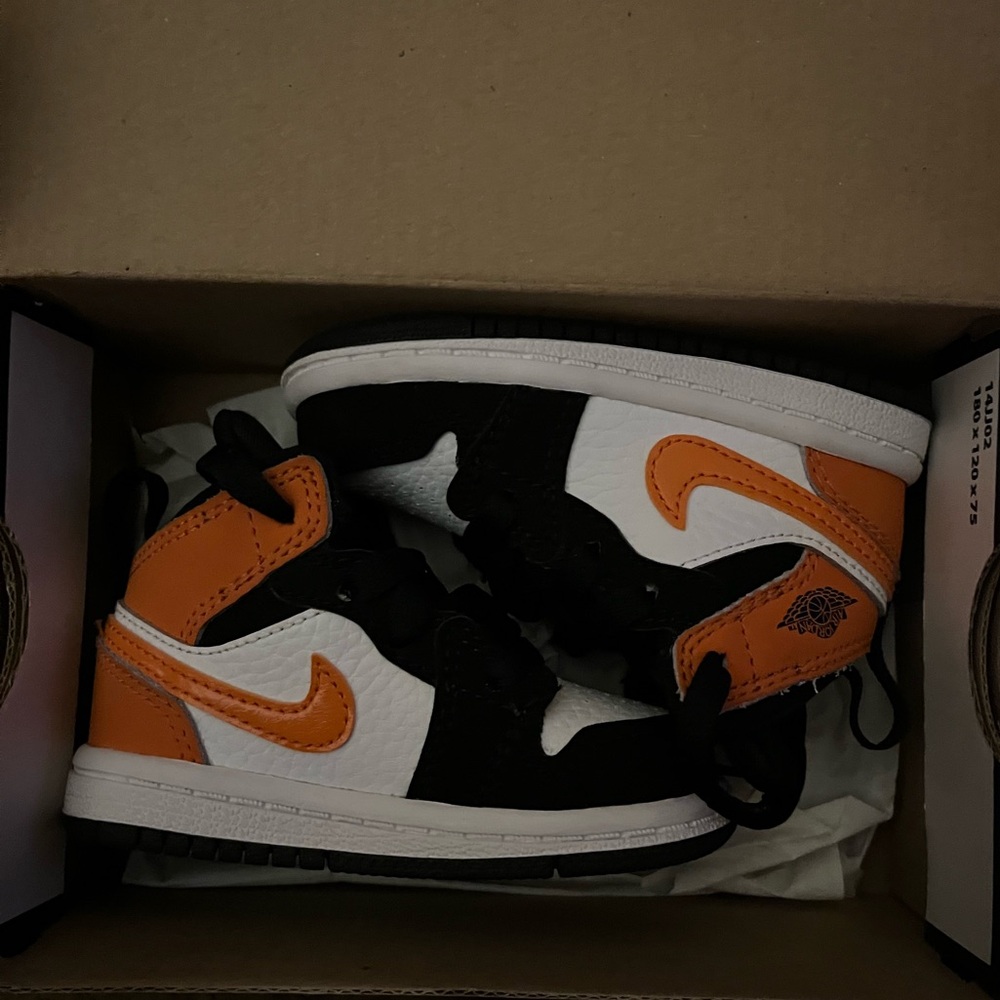 Orange and black Jordan 1 Mid